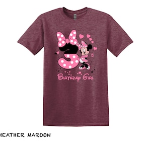 May include: Heather maroon t-shirt with a pink and white graphic of Minnie Mouse holding a number 3 and the text "Birthday Girl".