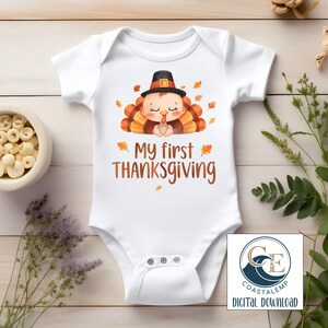 May include: White baby bodysuit with a Thanksgiving turkey graphic. The design features a cartoon turkey wearing a pilgrim hat, with the text "My first THANKSGIVING". The bodysuit has short sleeves and snap closures.