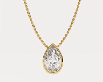 May include: A gold chain necklace with a pear-shaped diamond pendant set in a gold bezel.