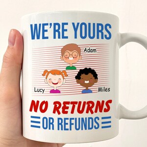 May include: White ceramic mug with a red and white striped background. The mug has the text "WE'RE YOURS" in blue letters and "NO RETURNS OR REFUNDS" in red letters. There are three cartoon children with names "Adam", "Lucy", and "Miles" on the mug.