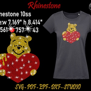 May include: Rhinestone design of Winnie the Pooh holding a red heart. The design is 7.169 inches wide and 8.414 inches tall. The design uses 561 yellow rhinestones, 757 red rhinestones, and 43 clear rhinestones.