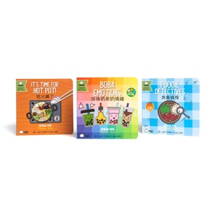 May include: Three illustrated children's books with colorful covers. The first book is orange and features a hot pot with chopsticks. The second book is rainbow colored and features boba tea. The third book is blue and features a plate of dumplings with a magnifying glass.