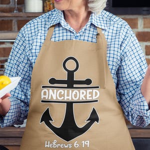 May include: A tan apron with a black anchor and the text "Anchored Hebrews 6:19".