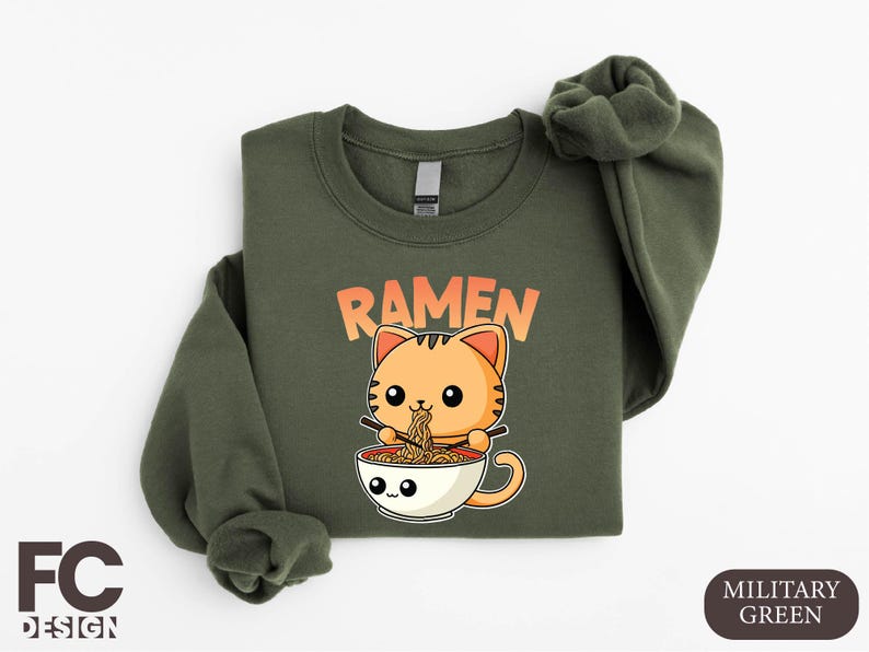 a green shirt with a cat in a cup of ramen