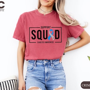 a woman wearing a t - shirt that says support squid