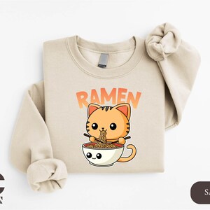 a t - shirt with a cat eating out of a bowl