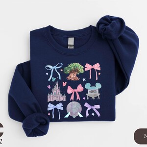 a blue shirt with a picture of a castle on it