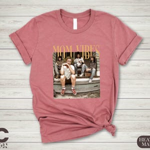 a women's t - shirt with a picture of a group of people sitting