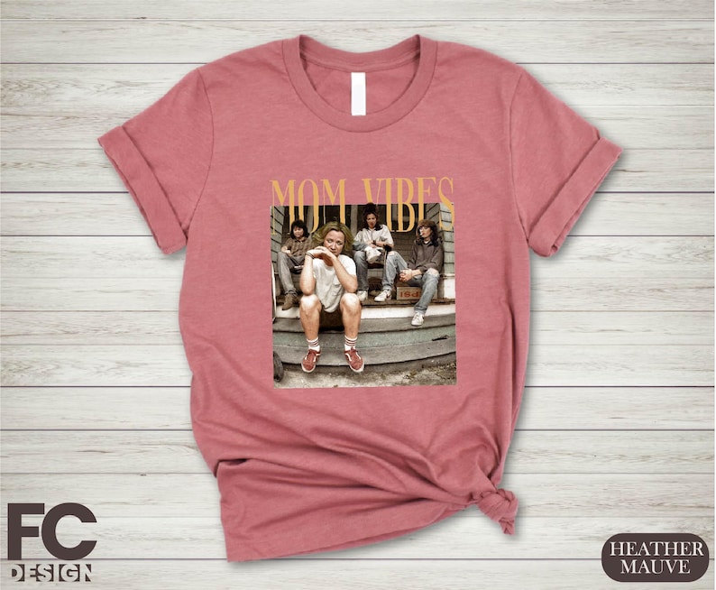 a women's t - shirt with a picture of a group of people sitting
