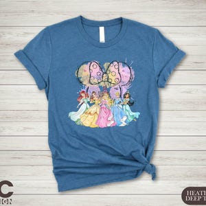 a women's t - shirt with an image of a group of princesses