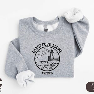 a gray sweatshirt with a lighthouse on it