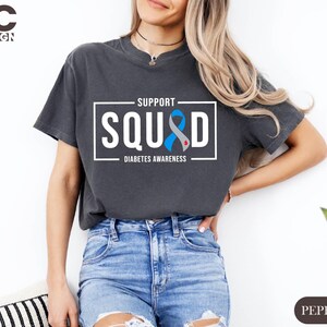 a woman wearing a t - shirt that says support squid