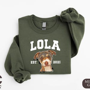 a green sweatshirt with a picture of a dog on it