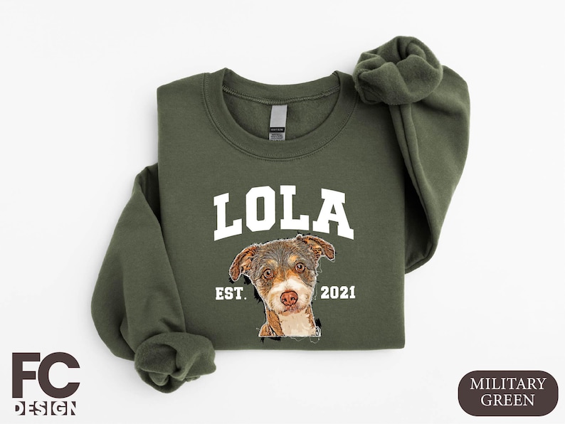 a green sweatshirt with a picture of a dog on it