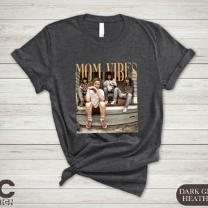 a t - shirt with a picture of a group of people sitting on the steps