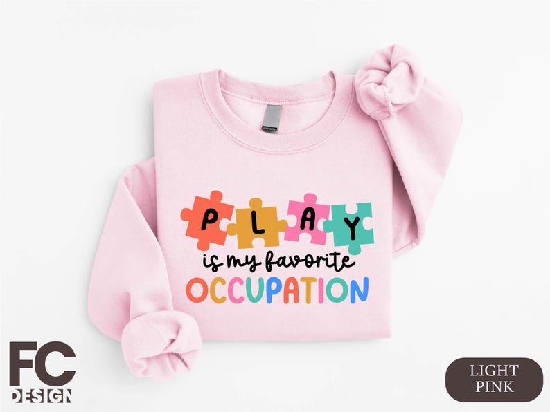 a pink shirt with puzzle pieces on it