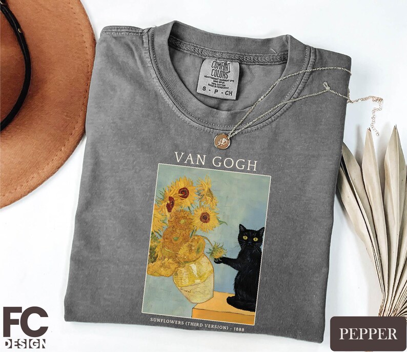 a t - shirt with a picture of a vase of sunflowers and a
