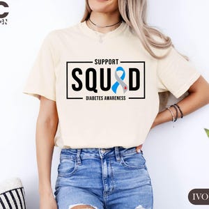 a woman wearing a t - shirt that says support squid
