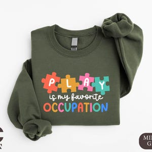 a green sweatshirt with puzzle pieces on it