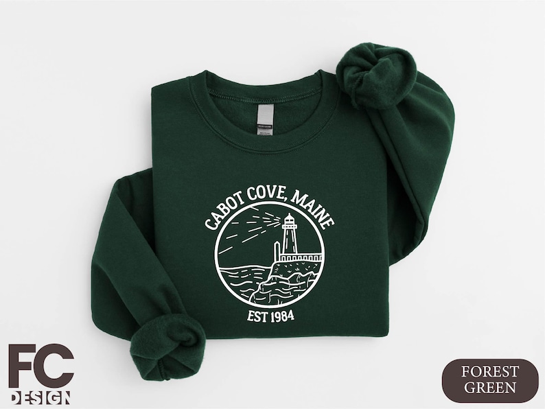a green sweatshirt with a lighthouse on it