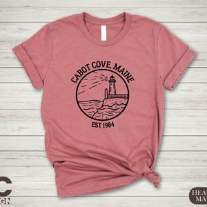 a pink shirt with a lighthouse on it