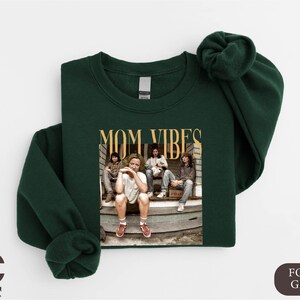 a green shirt with a picture of a group of people on it