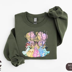 a green sweatshirt with a picture of a group of people on it