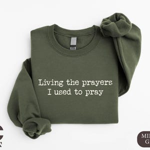 a t - shirt that says living the prayers i used to pray