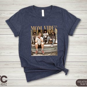 a women's t - shirt with a picture of a group of people sitting