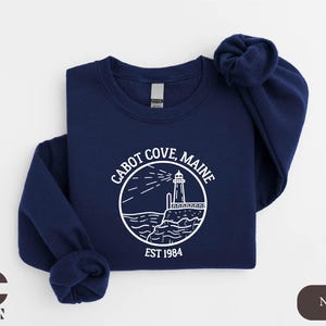 a navy sweatshirt with a lighthouse on it