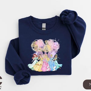 a blue sweatshirt with a picture of a group of princesses on it