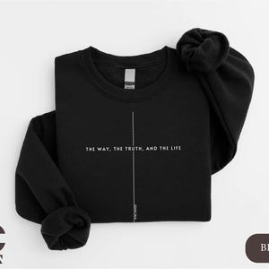 May include: Black sweatshirt with a white vertical line down the center and the text "The way, the truth, and the life" printed in white.