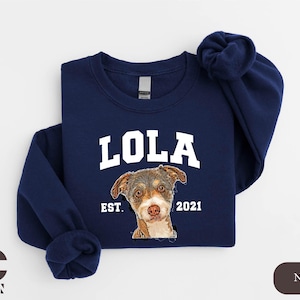 a blue sweatshirt with a picture of a dog on it
