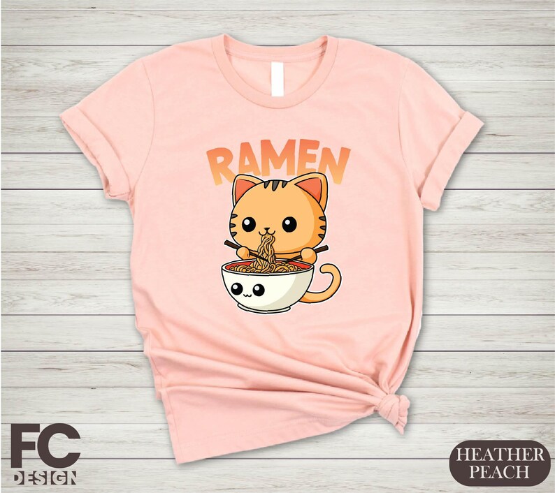 a women's t - shirt with a cat in a cup reading ramen