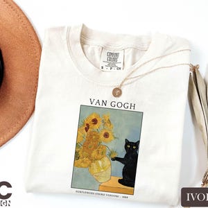 a t - shirt with a picture of a vase of sunflowers and a