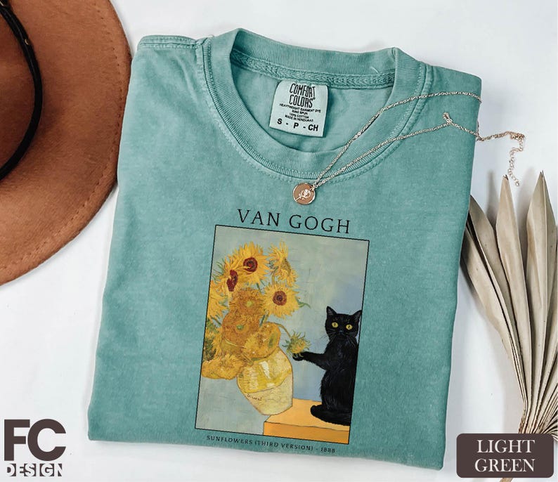 a t - shirt with a picture of a vase of sunflowers and a