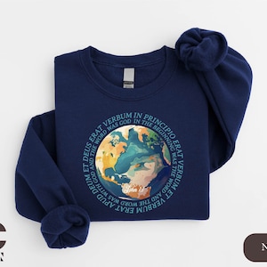 May include: A navy blue sweatshirt with a graphic of a colorful globe and the text "In the beginning was the Word, and the Word was with God, and the Word was God."  John 1:1