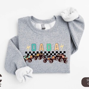 a gray shirt with a picture of a racing car on it