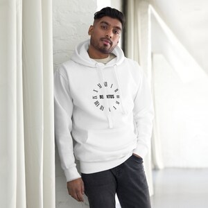 May include: White hooded sweatshirt with a black clock face design and the text "BE. VITOS" on the front.