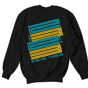 May include: Black sweatshirt with a geometric design in teal and yellow. The design includes three stars and the text "SNEAKER THIEFS" in teal. The sweatshirt is a crew neck style.