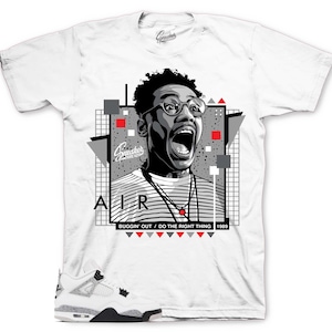 May include: White t-shirt featuring a graphic of a man with glasses and an open mouth, with the word "AIR" and the text "BUGGIN' OUT / DO THE RIGHT THING 1989". The shirt also has a pair of white, gray, and black sneakers.
