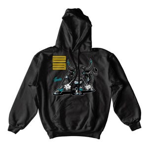 May include: Black hoodie featuring a bull graphic with teal and white accents. The design includes a stylized number 23 and the word "Sneakers" in teal. The hoodie has a drawstring hood and a kangaroo pocket.