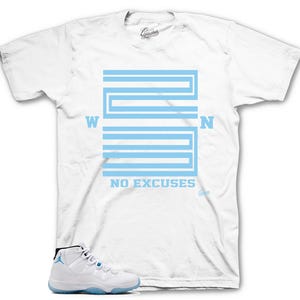 May include: White t-shirt with a light blue graphic of a basketball court with the words "NO EXCUSES" printed below. A pair of white and light blue sneakers are shown below the t-shirt.