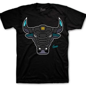 May include: Black t-shirt featuring a stylized bull head design. The bull head is primarily black with teal and gold accents, and a white outline. The word "Sneakers" is printed on the shirt.