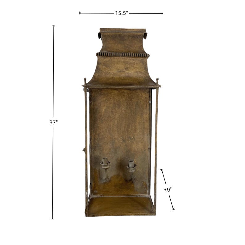 May include: A vintage-style, bronze-colored wall lantern. The lantern is 37 inches tall, 15.5 inches wide, and 10 inches deep. It features a decorative top and two candle holders inside. The metal has a distressed finish.
