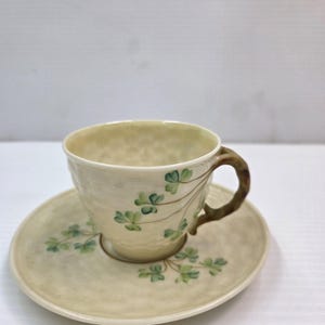 May include: A set of three ceramic mugs with a speckled, matte finish. The mugs are in shades of cream, light gray, and dark gray. Each mug has a simple, minimalist design, perfect for coffee or tea.