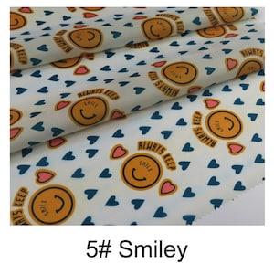 May include: White fabric with a repeating pattern of blue hearts, yellow smiley faces, and the text "ALWAYS KEEP SMILE".