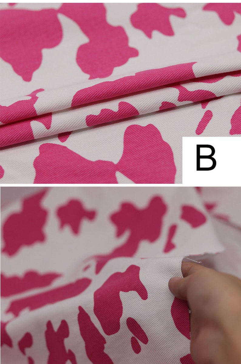 May include: Pink and white cow print fabric with a textured surface. The fabric is folded over and the letter "B" is visible in the upper right corner.