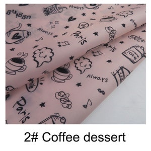 May include: Pink fabric with a black and white repeating pattern of coffee cups, stars, hearts, and the words "Paris", "Always", and "Cooking Love".