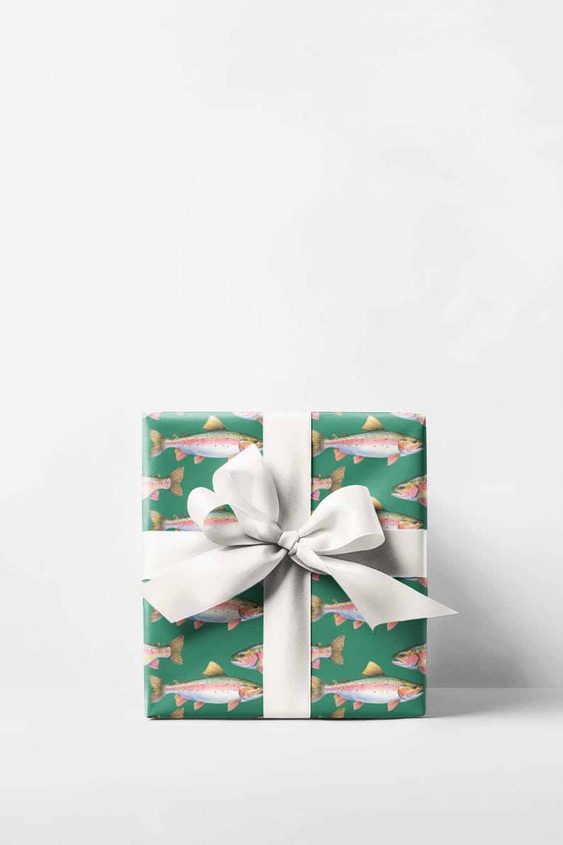 May include: A wrapped gift with green wrapping paper featuring a pattern of watercolor trout. The gift is tied with a white satin ribbon and bow. The trout are pink, yellow, and orange.